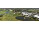 The golf course community features a pond with fountain and a clubhouse surrounded by mature trees at 174 Southampton S Pl # 345, Venice, FL 34293