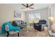 Comfortable living room featuring neutral tones, a ceiling fan, and natural light at 174 Southampton S Pl # 345, Venice, FL 34293