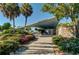 A shaded picnic area with a concrete overhang, stone walls and lush landscaping at 174 Southampton S Pl # 345, Venice, FL 34293