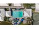 Top-down view of a community pool, umbrella-covered tables, and lounge chairs at 174 Southampton S Pl # 345, Venice, FL 34293