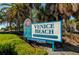 Brightly colored Venice Beach sign surrounded by green bushes and palm trees in a scenic park at 174 Southampton S Pl # 345, Venice, FL 34293