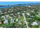 Expansive aerial view of a home with a private pool, lush landscaping, and a serene waterfront backdrop at 1773 Hudson St, Englewood, FL 34223