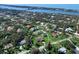 Aerial view of a home with mature landscaping and a screened-in pool close to the water at 1773 Hudson St, Englewood, FL 34223