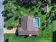 Aerial view of a home with mature landscaping and a screened-in pool at 1773 Hudson St, Englewood, FL 34223