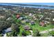 Aerial view of a home with mature landscaping and a screened-in pool close to the water at 1773 Hudson St, Englewood, FL 34223