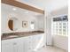 Bathroom featuring a double vanity with a granite countertop and unique glass block window at 1773 Hudson St, Englewood, FL 34223