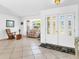 Foyer with tile flooring and decorative glass front doors offers a bright and welcoming entrance at 1773 Hudson St, Englewood, FL 34223