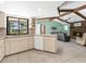 Open kitchen featuring white cabinets, tile floors, and breakfast bar overlooking the living room at 1773 Hudson St, Englewood, FL 34223