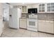 Well-equipped kitchen with white appliances and cabinets offers ample storage at 1773 Hudson St, Englewood, FL 34223