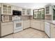 Bright kitchen featuring white cabinets, a tile backsplash, and modern appliances at 1773 Hudson St, Englewood, FL 34223