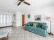 This living room features tile floors, a comfortable sofa, and bright light from front door at 1773 Hudson St, Englewood, FL 34223