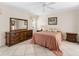 Comfortable main bedroom with tile flooring and coordinated furnishings at 1773 Hudson St, Englewood, FL 34223