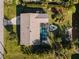 Overhead shot of home showing a large screened-in pool and meticulously landscaped grounds with access to the water at 18053 Cullman Ave, Port Charlotte, FL 33948