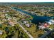 An aerial view shows a waterfront community along a navigable canal with beautiful views of a wide waterway at 18053 Cullman Ave, Port Charlotte, FL 33948