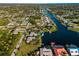 An aerial view shows a waterfront community along a navigable canal with beautiful views of a wide waterway at 18053 Cullman Ave, Port Charlotte, FL 33948