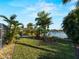 Spacious backyard with mature landscaping and water view at 18053 Cullman Ave, Port Charlotte, FL 33948