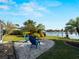 Relaxing backyard featuring water view, sandy lounging area with two Adirondack chairs at 18053 Cullman Ave, Port Charlotte, FL 33948