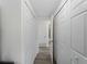 Hallway with multiple closet doors and wood flooring at 18053 Cullman Ave, Port Charlotte, FL 33948