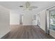 Spacious living room featuring wood floors, a front door, and a large window for natural light at 18053 Cullman Ave, Port Charlotte, FL 33948