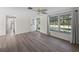 Inviting living room with wood floors and a large window, providing ample natural light at 18053 Cullman Ave, Port Charlotte, FL 33948