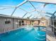 View of the screened pool, the lanai, and sliding glass doors to the interior at 18053 Cullman Ave, Port Charlotte, FL 33948