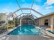 View of the screened pool area with nice landscaping and partial views of the interior at 18053 Cullman Ave, Port Charlotte, FL 33948