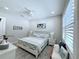 Bedroom with white furniture, shutters on the window, and light colored walls at 19836 Bridgetown Loop, Venice, FL 34293