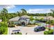 Welcoming community entrance with manicured landscaping, a guard house, and views of the lake at 19836 Bridgetown Loop, Venice, FL 34293