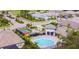 Aerial view of the community pool, tennis courts, and surrounding residential homes at 19836 Bridgetown Loop, Venice, FL 34293