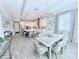 Dining room with bright light fixture with kitchen island, and six chairs at 19836 Bridgetown Loop, Venice, FL 34293