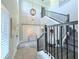 Bright foyer with staircase, modern light fixture, decorative wall, and hardwood floors at 19836 Bridgetown Loop, Venice, FL 34293