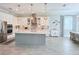 Bright kitchen with white cabinetry, a center island, and modern stainless-steel appliances at 19836 Bridgetown Loop, Venice, FL 34293