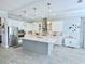 Modern kitchen featuring stainless steel appliances, pendant lighting, and a large center island at 19836 Bridgetown Loop, Venice, FL 34293