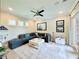 Bright living room with a gray sectional, white coffee table and light colored walls at 19836 Bridgetown Loop, Venice, FL 34293