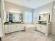 Luxurious main bathroom features double vanity sinks and a soaking tub at 19836 Bridgetown Loop, Venice, FL 34293