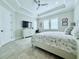 Serene main bedroom features a ceiling fan and natural light at 19836 Bridgetown Loop, Venice, FL 34293