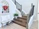 Elegant staircase featuring wood stairs, decorative railings, and a charming decorative mirror at 19836 Bridgetown Loop, Venice, FL 34293