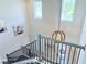 Staircase leading down to the front door, light-colored walls, and modern decor at 19836 Bridgetown Loop, Venice, FL 34293