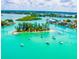 Picturesque aerial view of boats anchored near a sandy island, surrounded by crystal-clear turquoise waters at 200 Pameto Rd, Nokomis, FL 34275