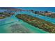 Scenic aerial shot of a waterway with boats, lush islands, and turquoise water at 200 Pameto Rd, Nokomis, FL 34275