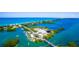 Aerial view of bridge, waterways, waterfront properties with ocean views at 200 Pameto Rd, Nokomis, FL 34275