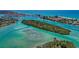 Scenic aerial view of waterway with boats, islands, and turquoise water near residential areas at 200 Pameto Rd, Nokomis, FL 34275