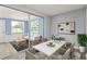 Bright dining room featuring modern furniture and sliding glass doors to sun room at 200 Pameto Rd, Nokomis, FL 34275