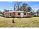 Charming single-story house with a well-maintained lawn and mature landscaping at 200 Pameto Rd, Nokomis, FL 34275