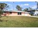 Exterior view of a single-story home, a well manicured lawn, and an attached garage at 200 Pameto Rd, Nokomis, FL 34275