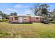 A charming single-story home with a well-maintained front lawn and a small trailer parked nearby at 200 Pameto Rd, Nokomis, FL 34275