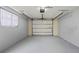 Clean, empty garage with an automatic door and a window at 200 Pameto Rd, Nokomis, FL 34275