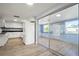 Well-lit kitchen featuring white cabinets, dark countertops, and view into sun room at 200 Pameto Rd, Nokomis, FL 34275