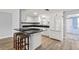 Kitchen featuring white cabinetry, modern appliances, and granite countertops at 200 Pameto Rd, Nokomis, FL 34275