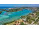 Aerial view of waterfront homes and dockage on serene turquoise waterways near beach at 200 Pameto Rd, Nokomis, FL 34275